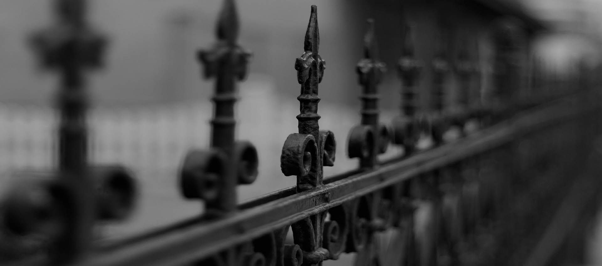 Ornate railings in the design of a Fleur di Lis in black and white